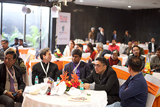 A group of people sitting at a round table at the UP textile trade event 2024.